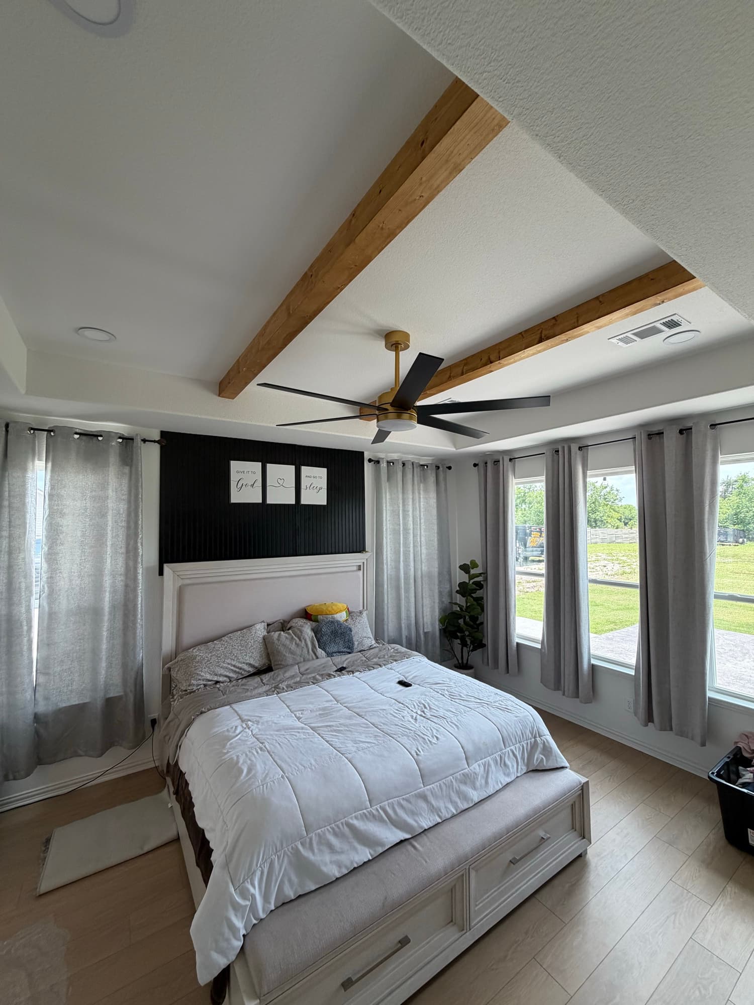 Master bedroom remodel with wood ceiling beams and accent wall