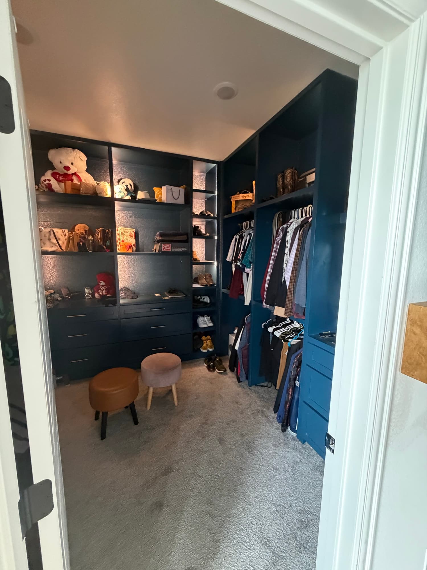 Custom walk-in closet with navy built-in shelving